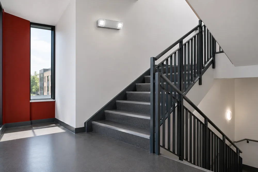 Emergency light fitting above a commercial stairwell landing
